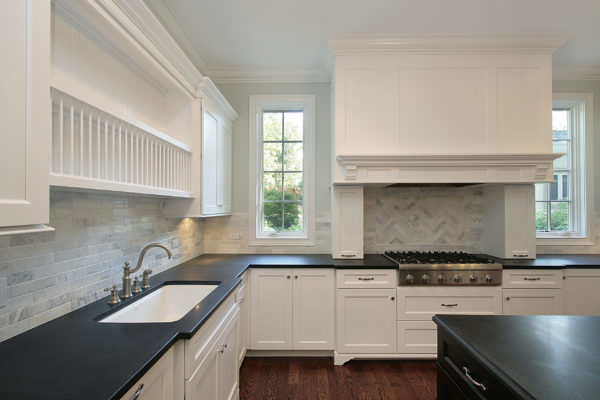Kitchen in new construction home with black countertops